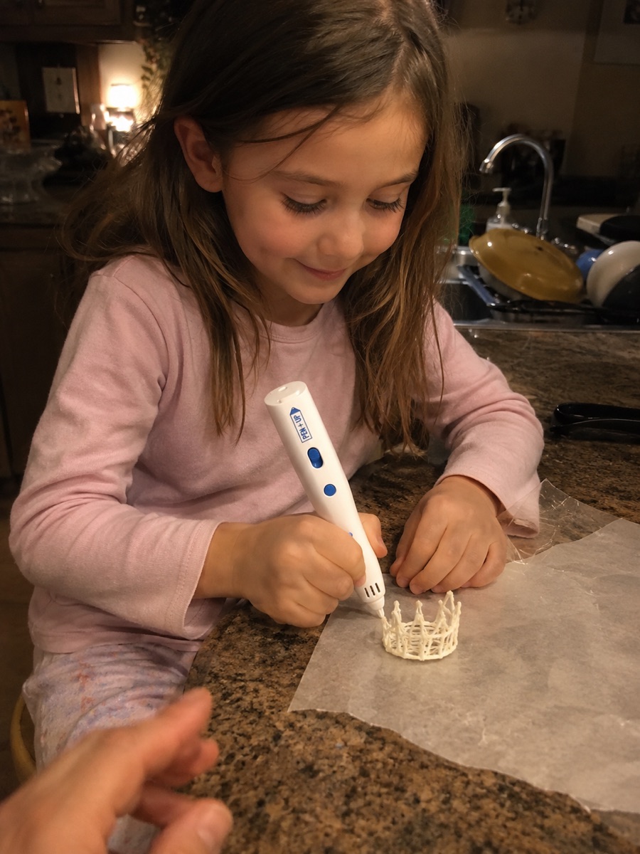 Une enfant crée un objet en 3D adapté à son âge avec le stylo Pen'Up 3D